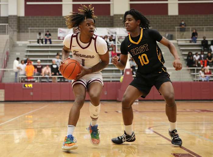 Lewisville's Landon Brown drives the lane against Plano East's Xavier Miller in a January 2023 game between the Farmers and Panthers.